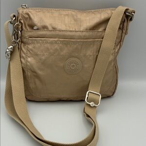 Kipling Beige Crossbody Bag with Silver Charm and Adjustable Strap